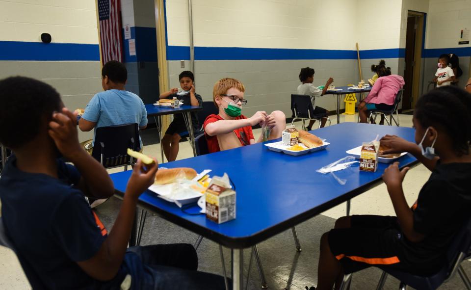 "My favorite part of lunch today is the dill pickle," Jace Bazzett, 10, (middle) of Lansing says while eating lunch with Khyrin Armstrong, left, 9, and Kali Bell, 7, at the Boys and Girls Club of Lansing, Friday, June 24, 2022.