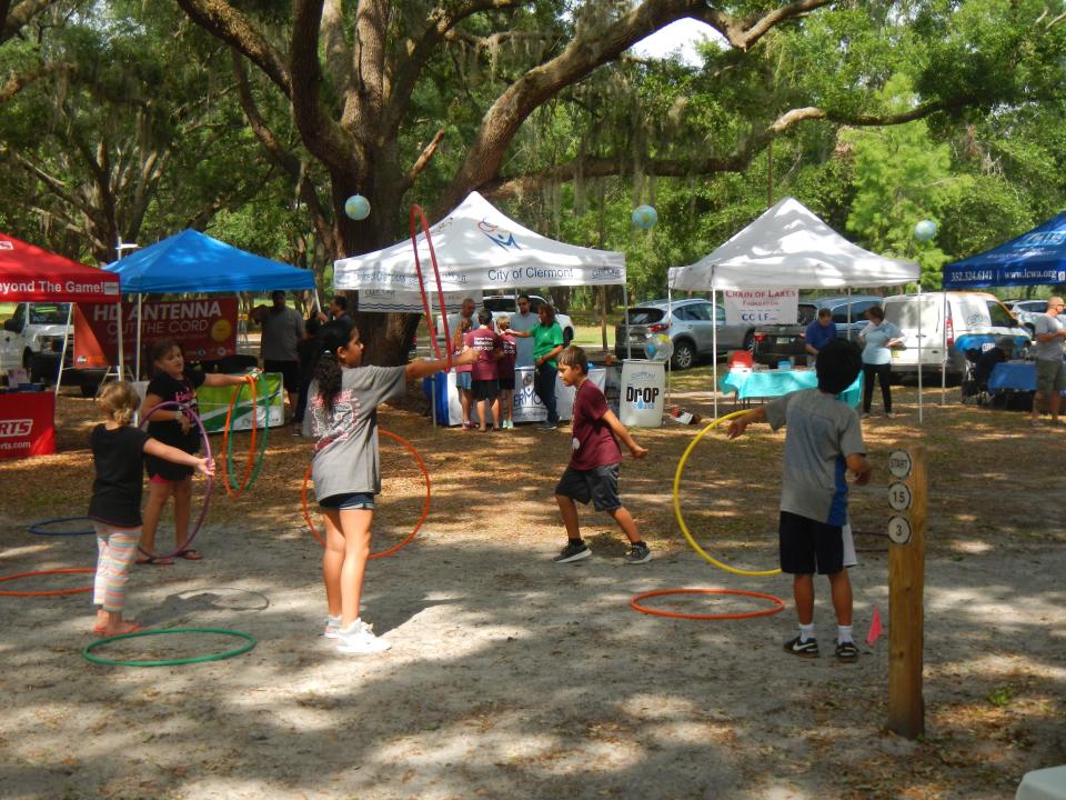 Kids engage in an earth-friendly pastme, the every popular hula hoop, at an Earth Day Celebration in Clermont