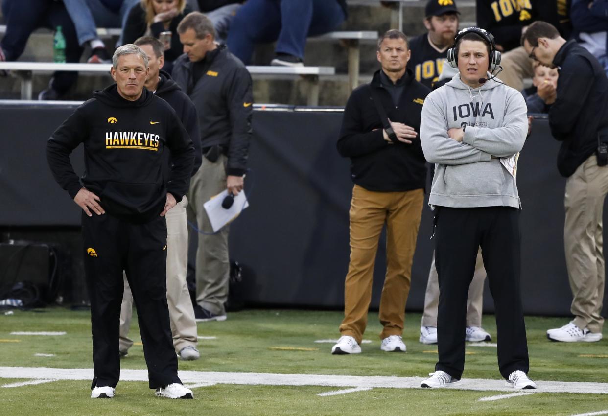 Iowa coach Kirk Ferentz (L) and his son and team offensive coordinator Brian Ferentz (R) watch from the sideline during the team’s NCAA college football spring game. (AP)