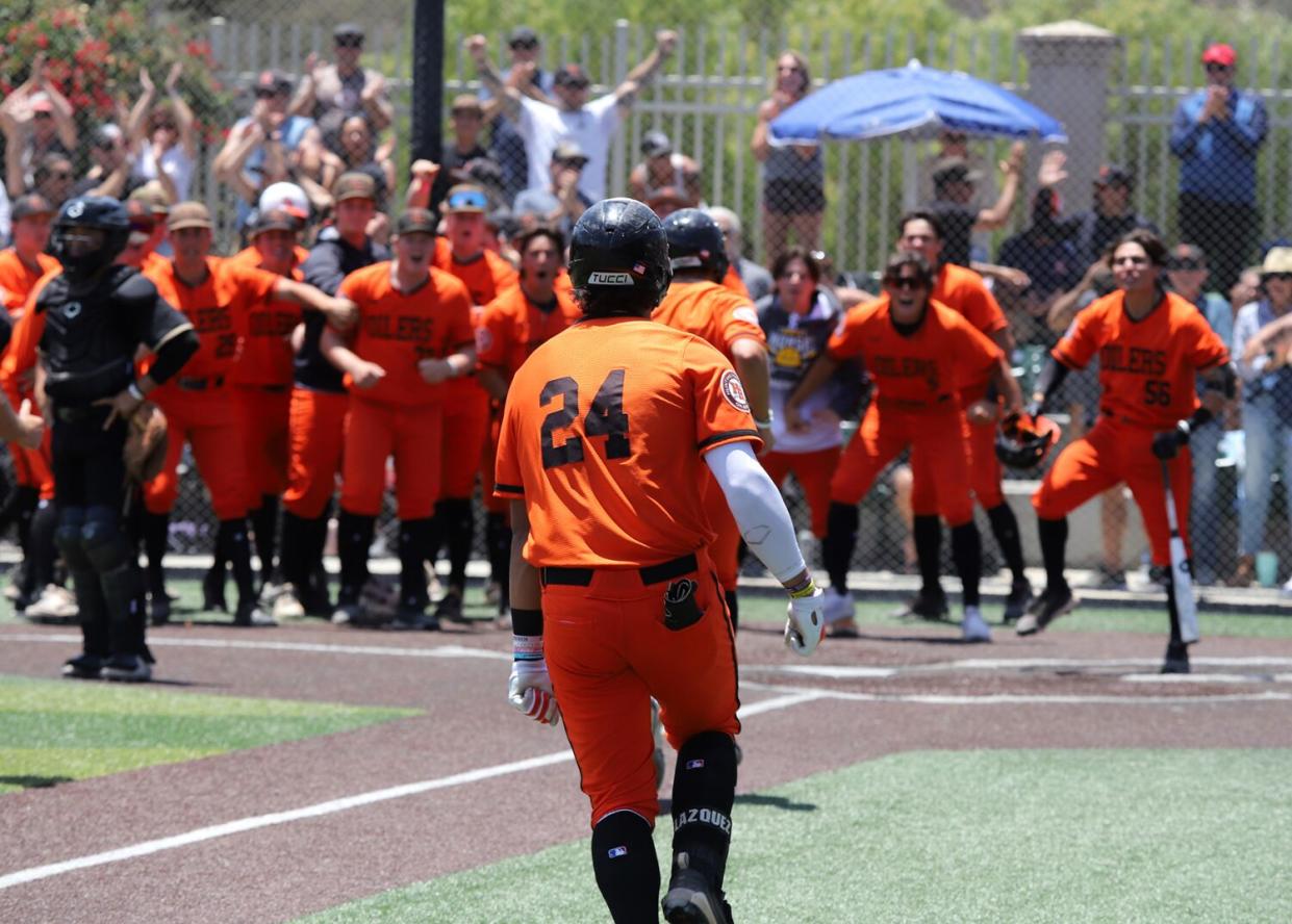 Huntington Beach's Ralphy Velazquez (24) heads toward home plate after hitting a walk-off home run in a playoff game.