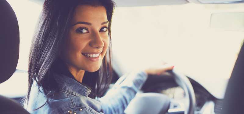 Smiling woman in a vehicle.