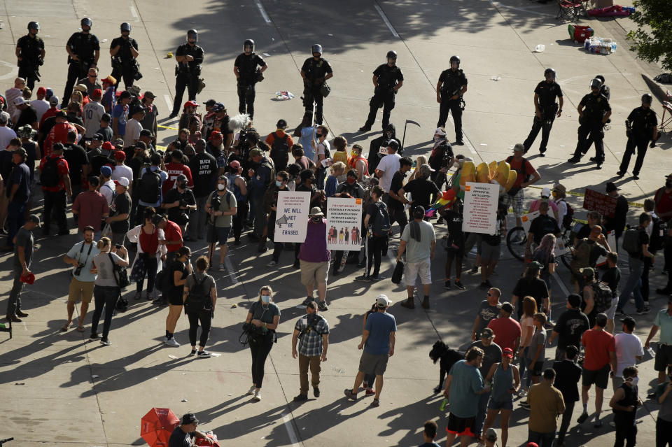 Protesters and supporters argue outside the BOK Center where President Trump will hold a campaign rally in Tulsa, Okla., Saturday, June 20, 2020. (AP Photo/Charlie Riedel)