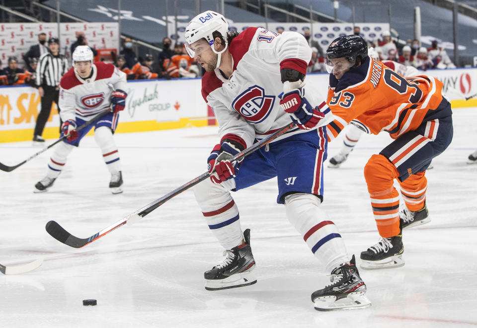 Edmonton Oilers' Ryan Nugent-Hopkins (93) chases Montreal Canadiens' Josh Anderson (17) during first-period NHL hockey game action in Edmonton, Alberta, Saturday, Jan. 16, 2021. (Jason Franson/The Canadian Press via AP)