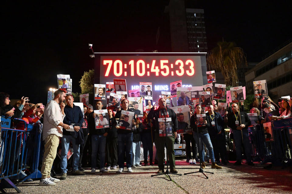 Families of Israeli hostages lift placards depicting their relatives. (Alberto Pizzoli / AFP via Getty Images)