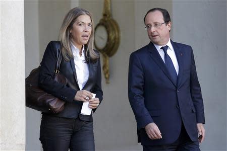 French President Francois Hollande (R) walks with French CEO of France Media Monde Marie-Christine Saragosse as she leaves the Elysee Palace following a meeting in Paris November 3, 2013. REUTERS/Gonzalo Fuentes