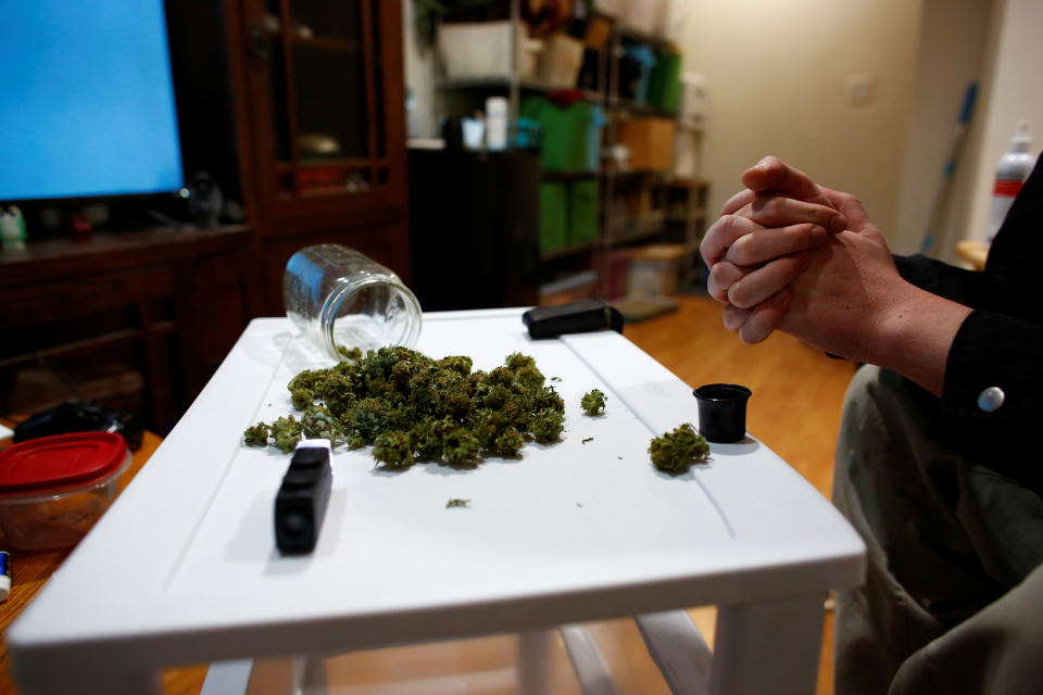 A participant in a University of Colorado study on the effects of cannabis, shows the marijuana flowers he has grown in his backyard, in Longmont, Colorado, U.S., December 19, 2019. REUTERS/Kevin Mohatt