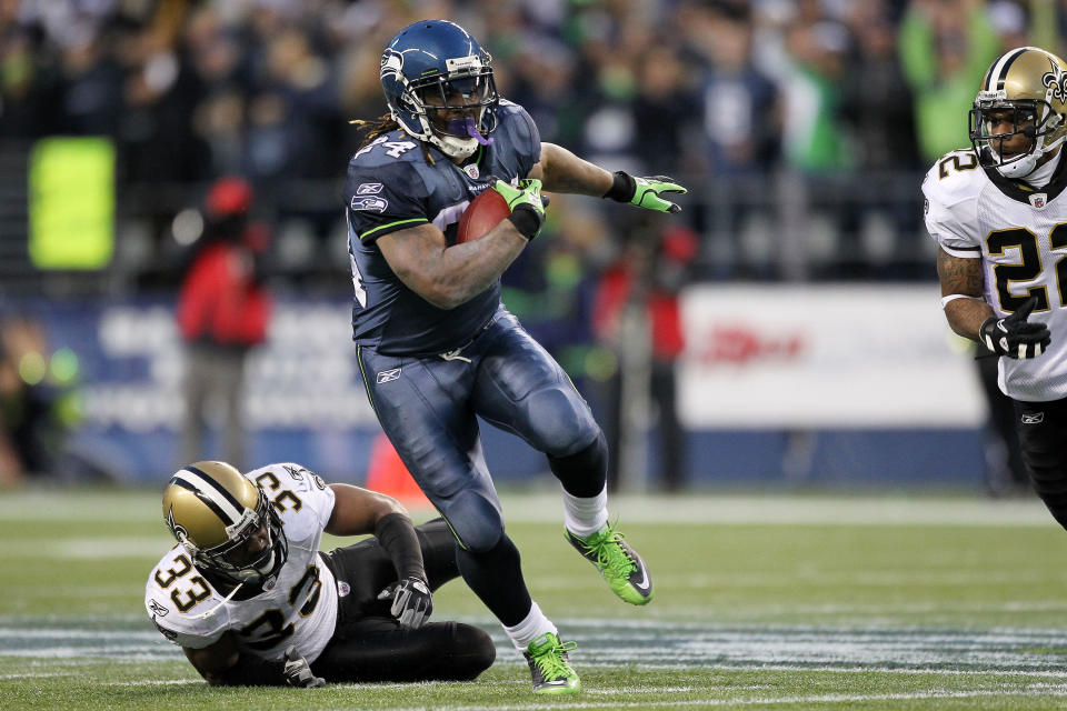 Marshawn Lynch of the Seattle Seahawks runs down field for a touchdown against the New Orleans Saints during the 2011 NFC Wild Card playoff game at Qwest Field on Jan. 8, 2011, in Seattle, Washington. / Credit: Otto Greule Jr / Getty Images