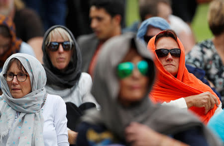 Women wearing headscarves as tribute to the victims of the mosque attacks are seen before Friday prayers at Hagley Park outside Al-Noor mosque in Christchurch, New Zealand March 22, 2019. REUTERS/Edgar Su