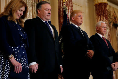 U.S. Secretary of State Mike Pompeo, his wife Susan, President Donald Trump and ‪Vice President Mike Pence bow their heads in prayer, during Pompeo's swearing-in ceremony,‬ at the Department of State in Washington, U.S., May 2, 2018. REUTERS/Leah Millis