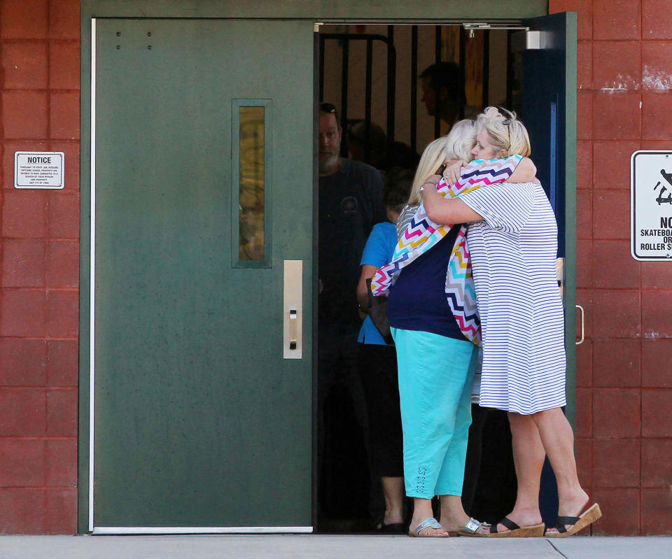 <p>Two teachers hug outside of Townville Elementary School after a shooting in Townville, S.C., on Sept. 28, 2016. (Nathan Gray/Reuters) </p>