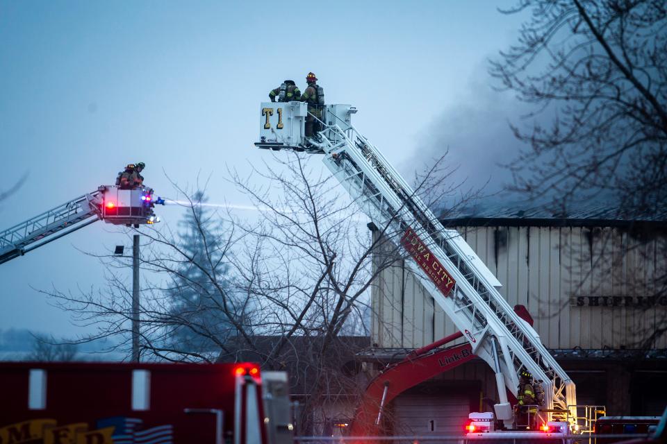 Firefighters work to control a blaze at  the C6-Zero on Dec. 8 in Marengo.