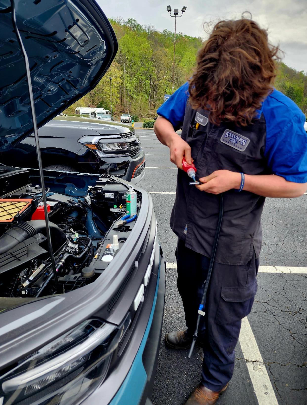 Repair tech Jacob Booth is doing a recall repair as part of the Stivers Ford mobile service in Birmingham, Alabama in February 2024.