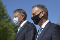 Polish President Andrzej Duda, right, reviews the honor guard with Romanian President Klaus Iohannis during the welcoming ceremony at the Cotroceni presidential palace in Bucharest, Romania, Monday, May 10, 2021. (AP Photo/Alexandru Dobre)