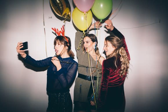 There young women take a selfie at a party.