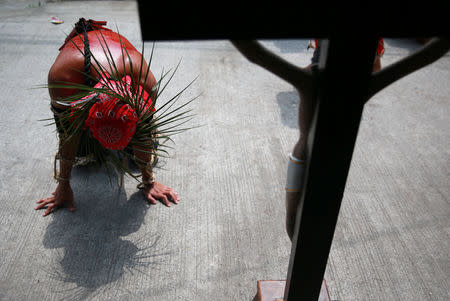 A Filipino penitent kneels before a crucifix after performing self-flagellation in Mabalacat City, Pampanga province, Philippines, April 18, 2019. REUTERS/Eloisa Lopez