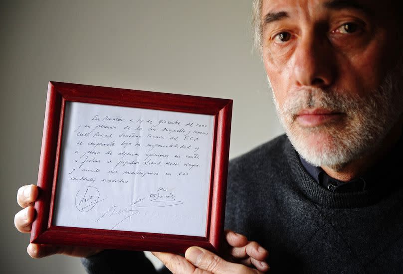 In this photo taken,5 January 2012, Horacio Gaggioli holds a framed copy of the napkin linking a 13-year-old Lionel Messi to FC Barcelona.