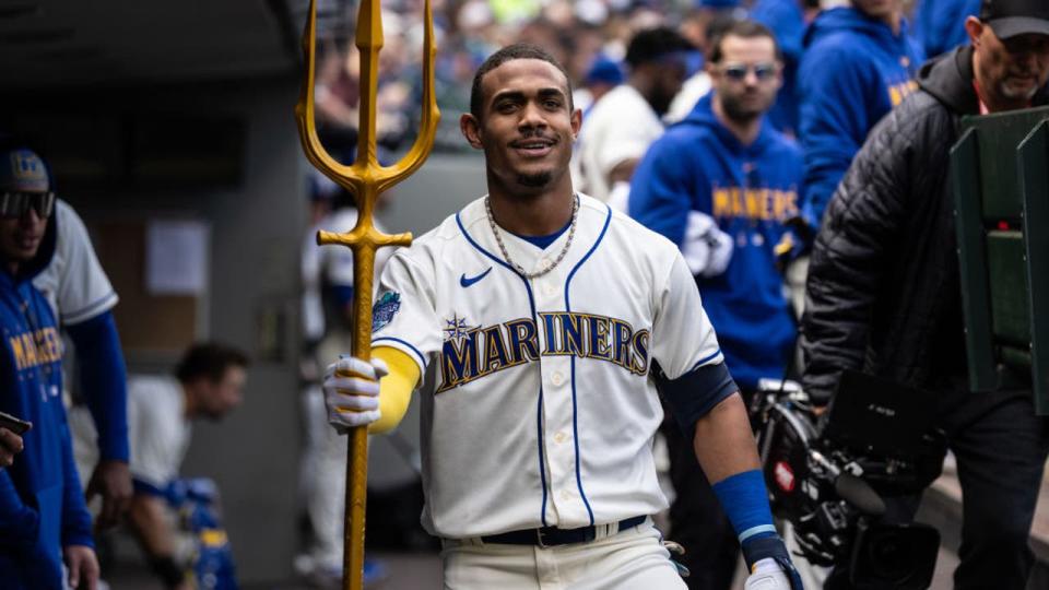 <div>Julio Rodriguez #44 of the Seattle Mariners poses with a trident in the dugout after hitting a solo home run against the Houston Astros during the second inning at T-Mobile Park on May 7, 2023 in Seattle, Washington.</div> <strong>(Photo by Stephen Brashear/Getty Images)</strong>