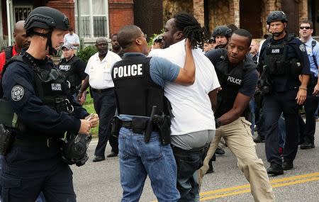 Police arrest a protester that was in the middle of the street after a shooting incident in St. Louis, Missouri August 19, 2015. REUTERS/Lawrence Bryant