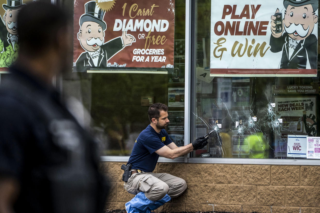 Bullet holes are seen in the window of Tops Friendly Market at Jefferson Avenue and Riley Street, as federal investigators work the scene of a mass shooting on May 16, 2022 in Buffalo, N.Y. (Kent Nishimura / Los Angeles Times via Getty Images file)