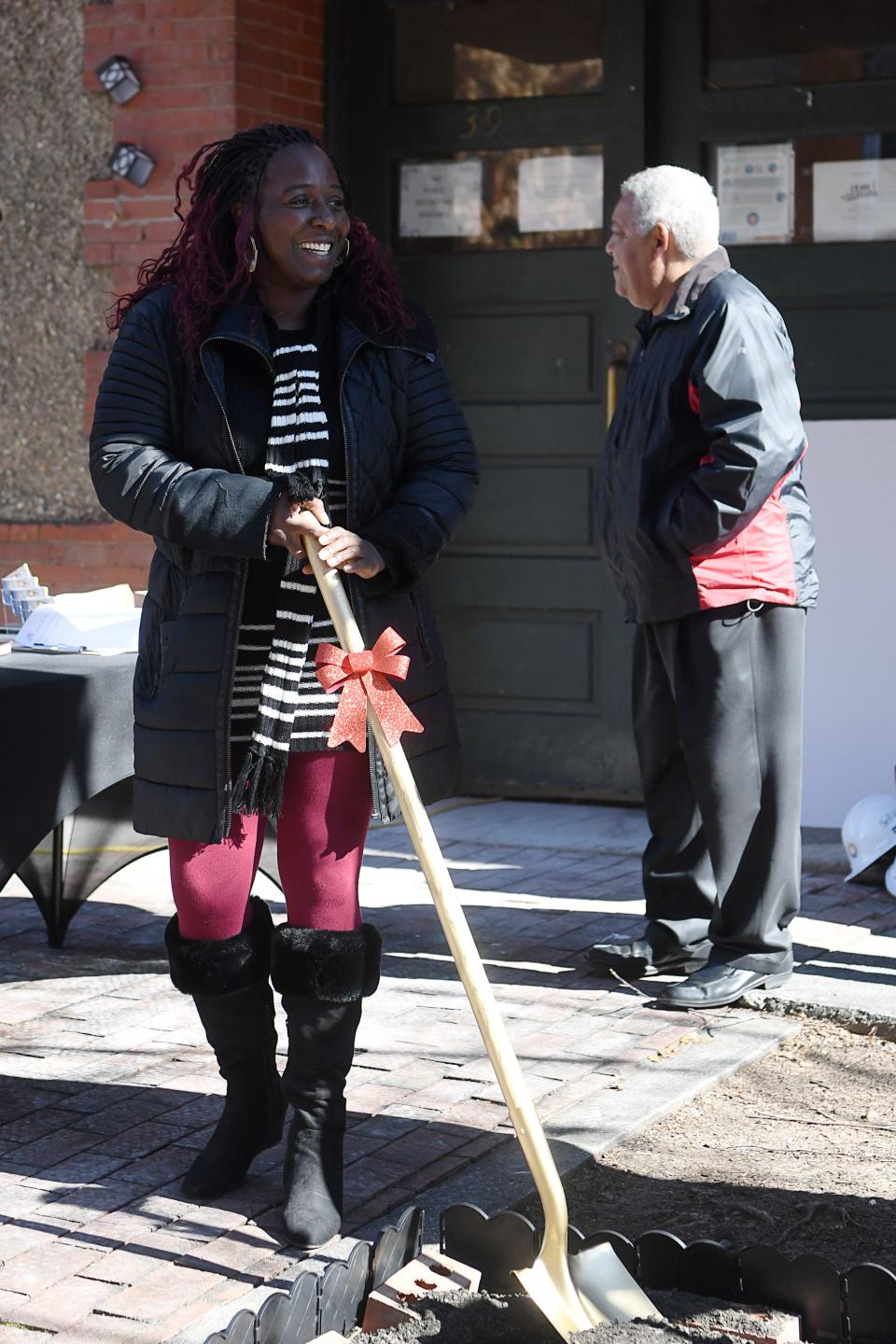 Dewana Little, executive director of the YMI Cultural Center, holds a shovel after “breaking ground” on the center’s renovations November 17, 2022.