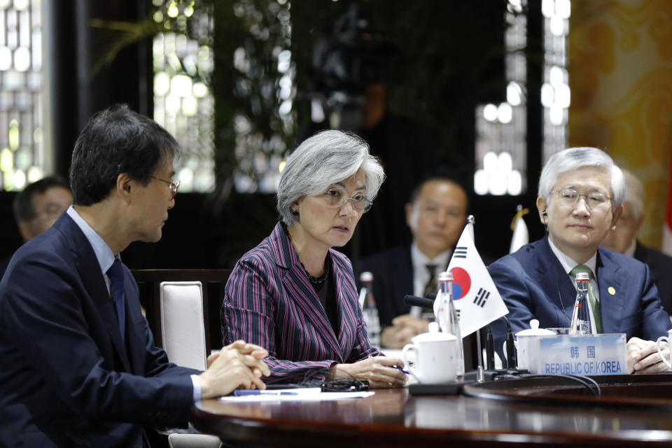 South Korean Foreign Minister Kang Kyung-wha, center, speaks with her Japanese counterpart Taro Kono and Chinese counterpart Wang Yi during their trilateral meeting at Gubei Town in Beijing Wednesday, Aug. 21, 2019. (Wu Hong/Pool Photo via AP)
