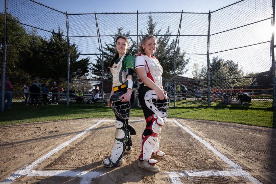 Clinton catcher Emily Johns, left, and Hudson catcher Lauren O'Malley pose before facing each other on Monday.