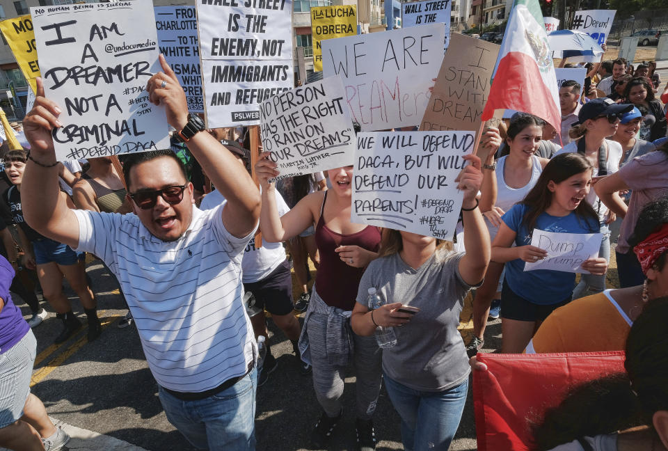 <p>Supporters of the Deferred Action for Childhood Arrivals, or DACA chant slogans and holds signs while joining a Labor Day rally in downtown Los Angeles on Monday, Sept. 4, 2017. (Photo: Richard Vogel/AP) </p>