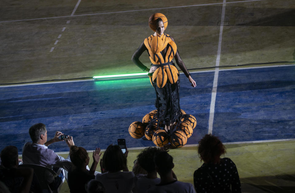 A model wears a creation from "Clandestina," the first Cuban independent urban fashion brand, during a launch for the 2020 collection called Sports Glories in Havana, Cuba, Friday, Nov. 22, 2019. (AP Photo/Ramon Espinosa)