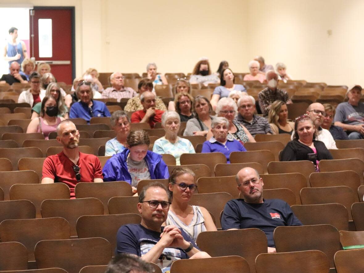 About 80 people attended the meeting in the Harrison Trimble High School auditorium.  (Shane Magee/CBC - image credit)