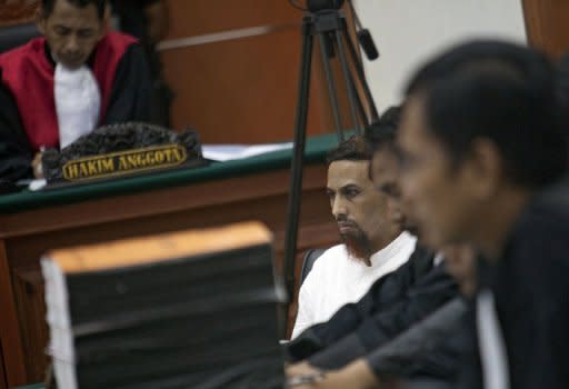 Indonesian Muslim militant and suspected Bali bomber Umar Patek (C) sits listening to a witness at his trial in Jakarta on April 12, 2012. Patek, 45, went on trial in February, charged with murder, bomb-making and illegal firearms possession