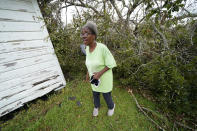 Wyna Dennis shows the damage to her home from fallen trees before she leaves Lake Charles, La., in the aftermath of Hurricane Laura, Sunday, Aug. 30, 2020. (AP Photo/Gerald Herbert)