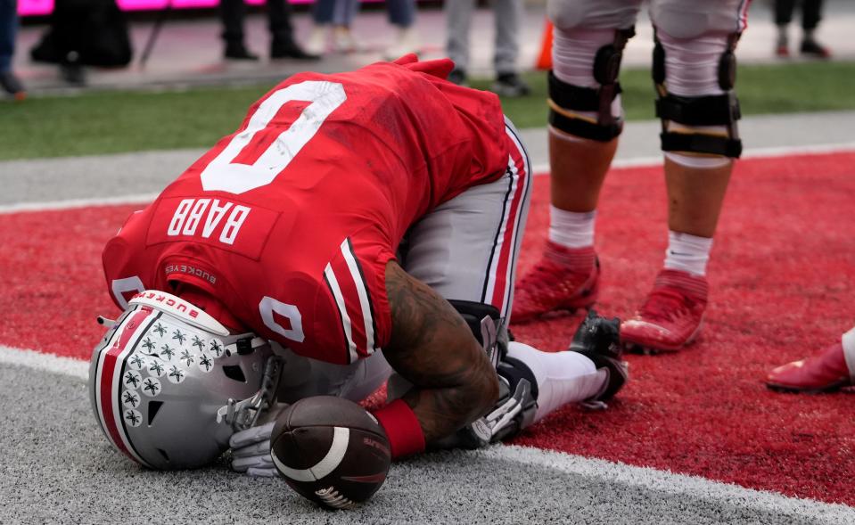 Ohio State wide receiver Kamryn Babb prays following an 8-yard touchdown catch against Indiana.