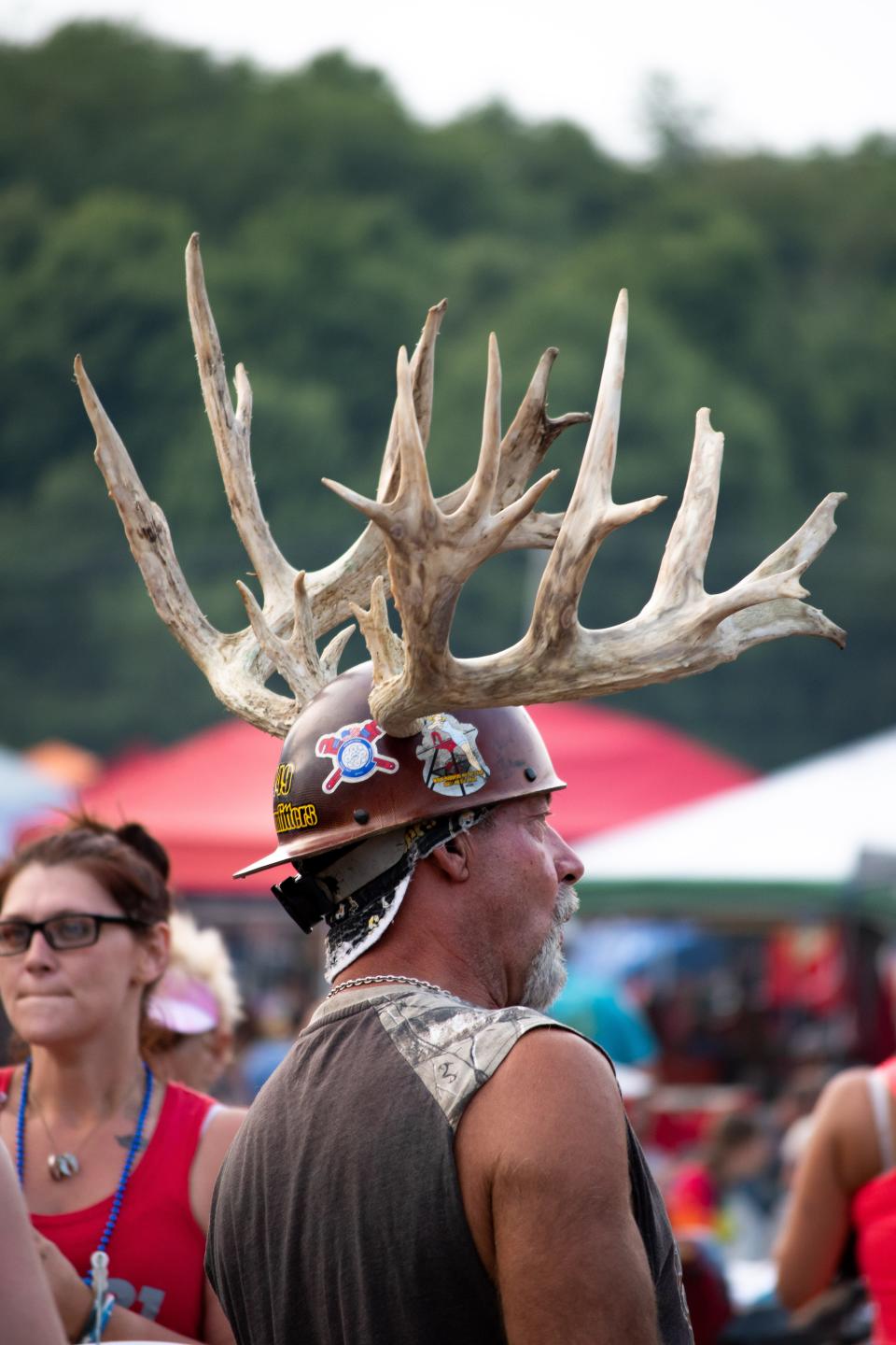 Wearing a large rack, a Deerassic Classic attendee carefully makes his way through the crowd.