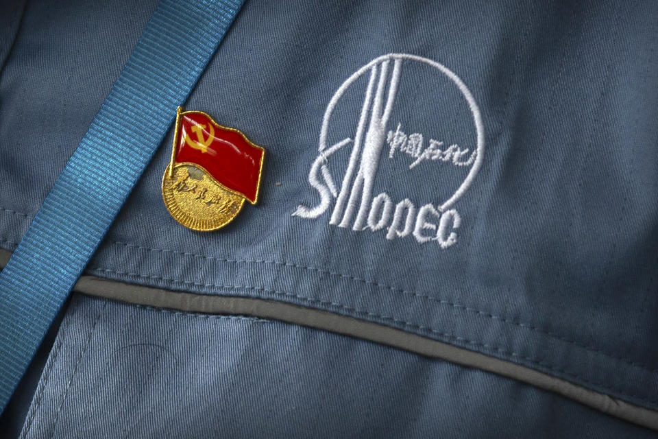 FILE - A Chinese Communist Party badge is pinned to a worker's uniform at the Sinopec Yanshan Petrochemical Company on the outskirts of Beijing on May 25, 2018. Three state-owned Chinese corporate giants announced plans Friday, Aug. 12, 2022, to remove their shares from the New York Stock Exchange amid a dispute between Washington and Beijing over whether U.S. regulators can see records of their auditors. PetroChina, China Life and China Petroleum & Chemical, widely known as Sinopec, said the shares affected were American depositary shares, or ADSs, that represent shares traded in Hong Kong. (AP Photo/Mark Schiefelbein)