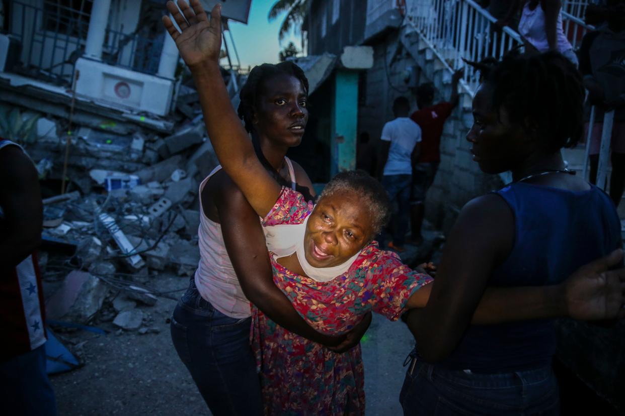 Oxiliene Morency cries out in grief after the body of her 7-year-old-daughter Esther Daniel was recovered from the rubble of their home after an earthquake in Les Cayes, Haiti, Saturday, Aug. 14, 2021.