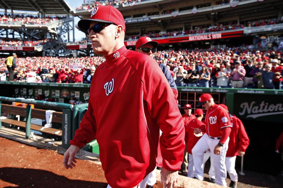 Washington Nationals manager Matt Williams, left, comes out to congratulate his team after a baseball game against the Atlanta Braves at Nationals Park, Sunday, April 6, 2014, in Washington. The Nationals won 2-1. (AP Photo/Alex Brandon)