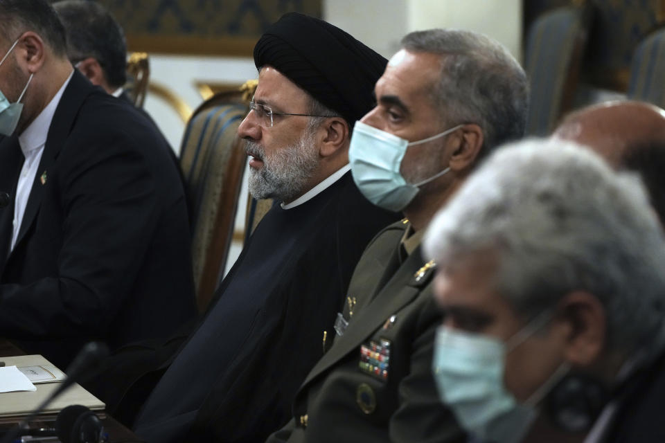 Iranian President Ebrahim Raisi listens to his Venezuelan counterpart Nicolas Maduro during their round of talks at the Saadabad Palace in Tehran, Iran, Saturday, June 11, 2022. (AP Photo/Vahid Salemi)