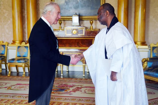<p>VICTORIA JONES/POOL/AFP via Getty </p> King CHarles and Samba Mamadou BA, Mauritania's Ambassador, on March 6, 2024 Buckingham Palace in London, 2024 at