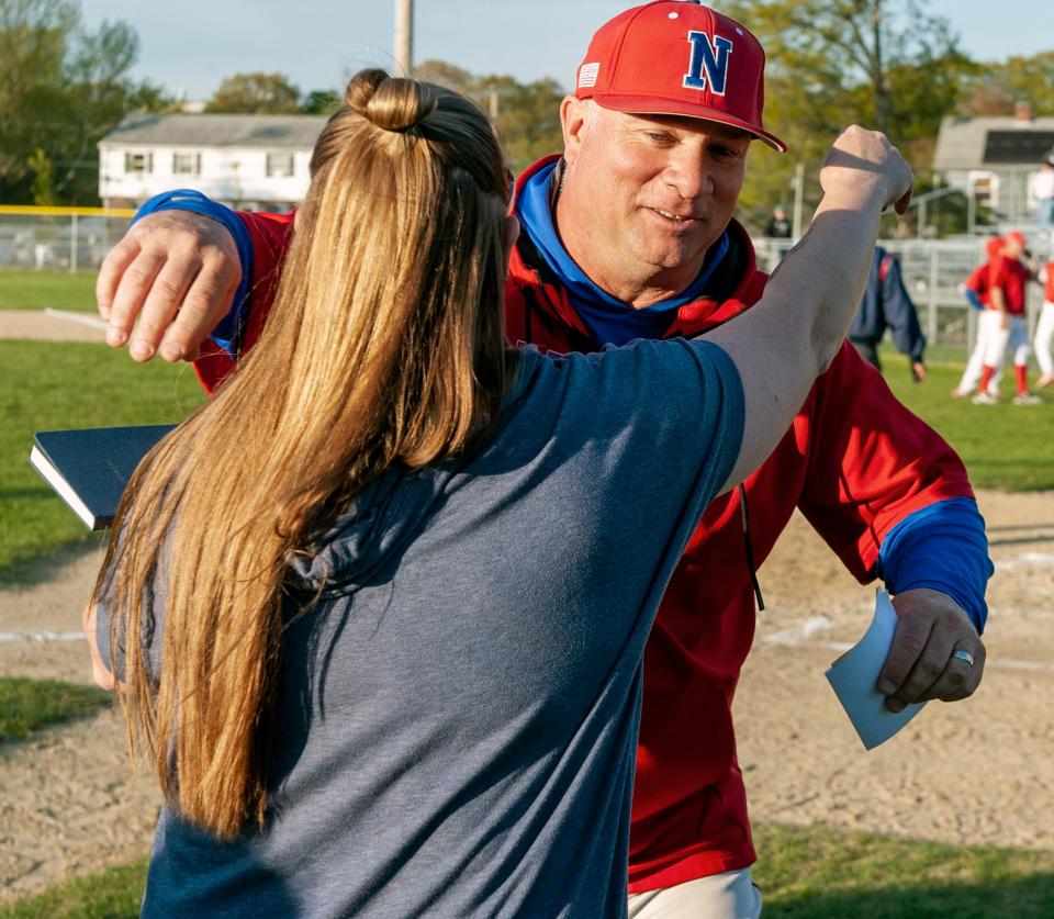 Natick High School Baseball Coach Jason Hoye hugs Amanda Smith, daughter of Paul "Bunkie" Smith, before the Paul "Bunkie" Smith Memorial game between Framingham High School and Natick High School, May 13, 2024. Smith, a former coach and player, died Sept. 24, 2023.