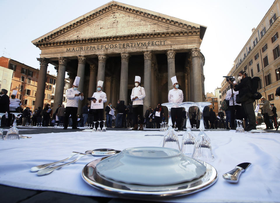 Cooks and restaurant owners protest against the government restriction measures to curb the spread of COVID-19, closing restaurants at night, at Rome's Pantheon Square, Wednesday, Oct. 28, 2020. (AP Photo/Alessandra Tarantino)