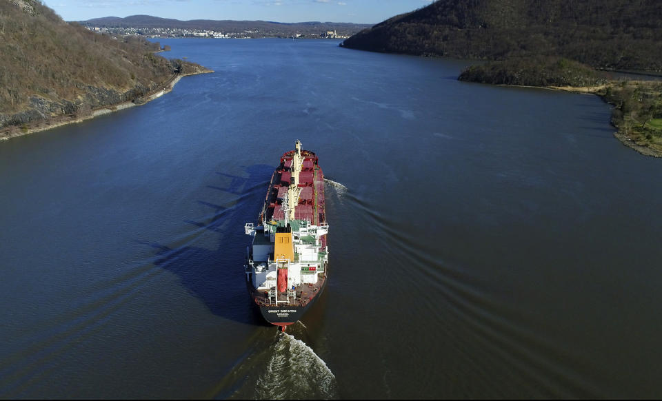 FILE- In this April 26, 2018, file photo, the Orient Dispatch, a bulk carrier ship, makes its way south on the Hudson River near Peekskill, N.Y. New York officials who are pushing for additional cleanup of the Hudson River followed through Wednesday, Aug. 21, 2019 on their promise of a lawsuit against the U.S. Environmental Protection Agency. The federal lawsuit seeks to overturn the EPA's decision in April not to compel General Electric to restart dredging for polychlorinated biphenyls from the upper river. Agency officials had said more time and testing are needed to fully assess the $1.7 billion Superfund cleanup. (AP Photo/Julie Jacobson, File)