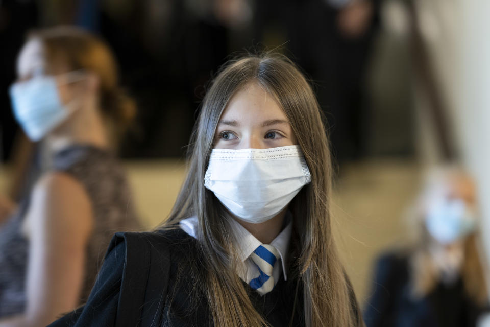 CARDIFF, WALES - SEPTEMBER 20: A child wearing a face mask looks on at Llanishen High School on September 20, 2021 in Cardiff, Wales. All children aged 12 to 15 across the UK will be offered a dose of the Pfizer-BioNTech Covid-19 vaccine. Parental consent will be sought for the schools-based vaccination programme. (Photo by Matthew Horwood/Getty Images)