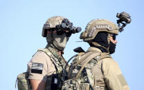 A U.S. Navy SEAL special forces operator, left, stands with a colleague during a joint U.S.-Cyprus military drill at Limassol port on Friday, Sept. 10, 2021. Cyprus' Defense Minister Charalambos Petrides said the U.S. and Cyprus are on the same strategic path to ensure security and stability in a turbulent region and that continued close cooperation between the special forces of both countries aim to counter threats from potential terrorist acts. (AP Photo/Philippos Christou)