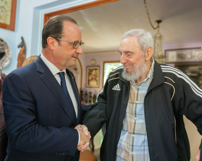 Hollande (L) shaking hands with Cuban historical leader Fidel Castro during a meeting in Havana on May 11, 2015