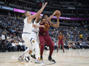 Cleveland Cavaliers center Jarrett Allen, right, goes up for a shot as Denver Nuggets forward Aaron Gordon and center Nikola Jokic, left, defend in the first half of an NBA basketball game Monday, Oct. 25, 2021, in Denver. (AP Photo/David Zalubowski)