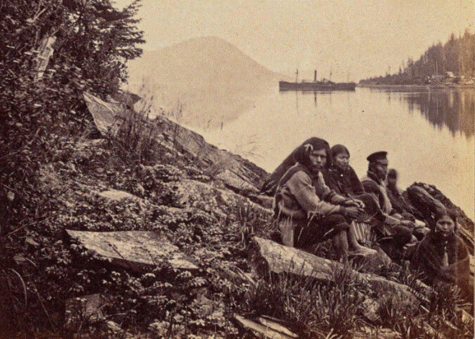 Tlingit people at Fort Wrangle, Alaska with the Pacific at anchor in the background in 1868. Photographer Eadweard Muybridge accompanied Major-General Henry W. Halleck, commander of the U.S. Military Division of the Pacific, on a trip to Alaska onboard the Pacific. Halleck was on an inspection tour of the territory purchased that year from Russia.