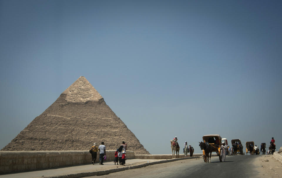 In this Thursday, Sept. 27, 2012 photo, foreign tourists visit the historical site of the Giza Pyramids, near Cairo, Egypt. The Egyptian demonstrations against an online film that was produced by a U.S. citizen originally from Egypt and denigrates the Prophet Muhammad were part of a wider explosion of anger in Muslim countries. They happened near the U.S. Embassy, far from the pyramids of Giza on Cairo's outskirts, and a lot further from gated Red Sea resorts, cocoons for the beach-bound vacationer. Yet the online or TV images _ flames, barricades, whooping demonstrators _ are a killjoy for anyone planning a getaway, even though the protests have largely subsided. Tour guides in Egypt say tourist bookings are mostly holding, but they worry about a dropoff early next year, since people tend to plan several months ahead.(AP Photo/Khalil Hamra)