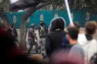 A member of Iraqi security forces holds his gun during ongoing anti-government protests in Baghdad