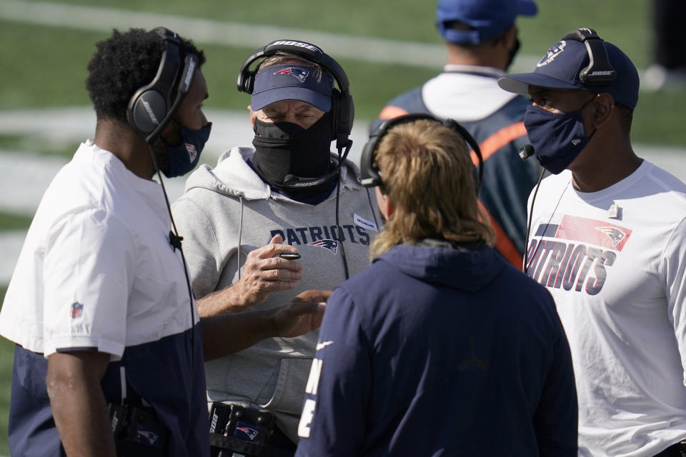 New England Patriots head coach Bill Belichick, center, consults with defensive coaches in the first half of an NFL football game against the Denver Broncos, Sunday, Oct. 18, 2020, in Foxborough, Mass. (AP Photo/Charles Krupa)