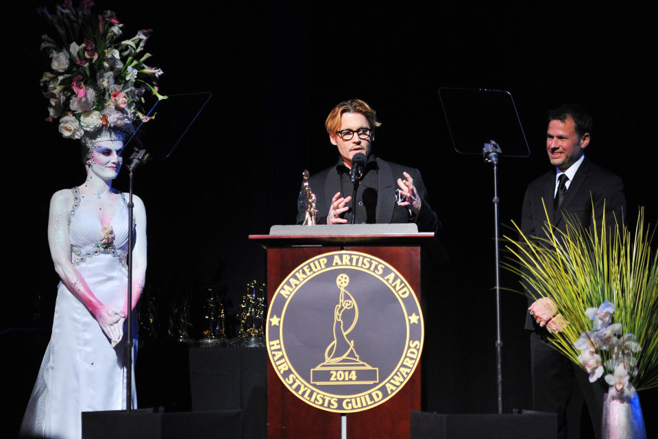 Actor Johnny Depp (C) speaks after accepting the Distinguished Artisan Award at The Make-Up Artists and Hair Stylists Guild Awards on Saturday, Feb. 15, 2014 at Paramount Studios in Los Angeles, California. Make-up artist Joel Harlow(R) presented the award. (Photo by Vince Bucci/Invision/AP)